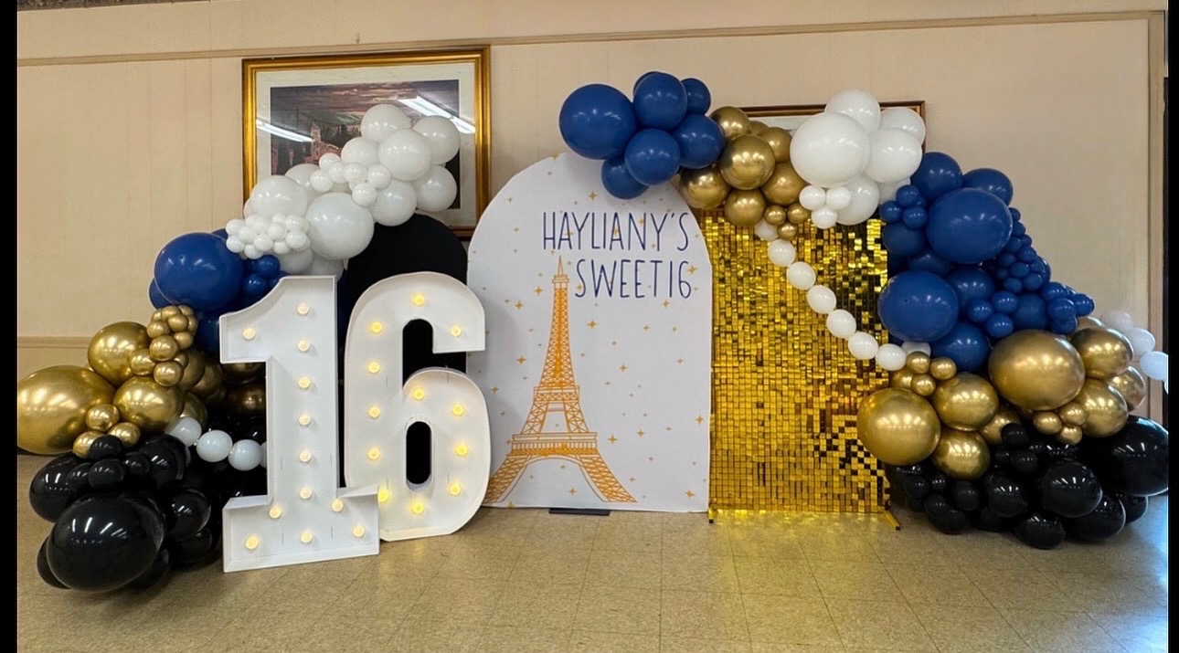 Paris-themed Sweet 16 balloon arch with marquee number and gold shimmer wall